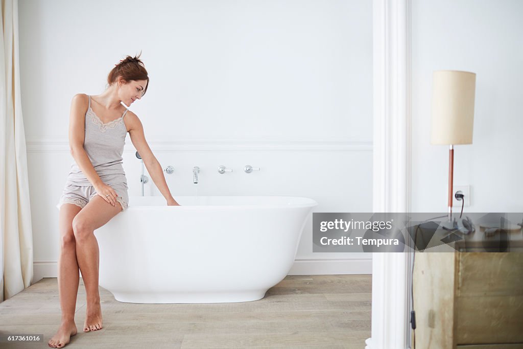 Woman relaxing a luxury bathroom.