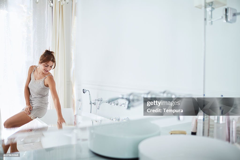 Woman relaxing a luxury bathroom.