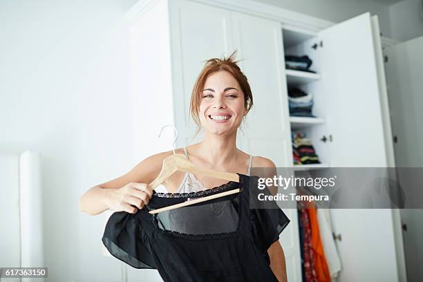 deciding what to wear for the party. - wardrobe stockfoto's en -beelden