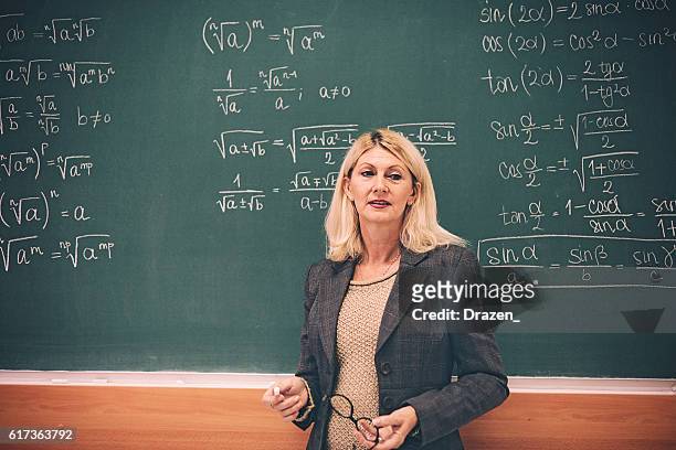 portrait of math professor in lecture hall - teacher board stock pictures, royalty-free photos & images