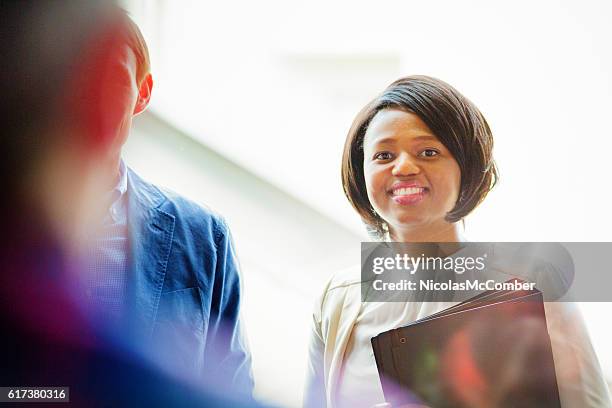 smiling young black female office worker ready for training - day 1 stock pictures, royalty-free photos & images