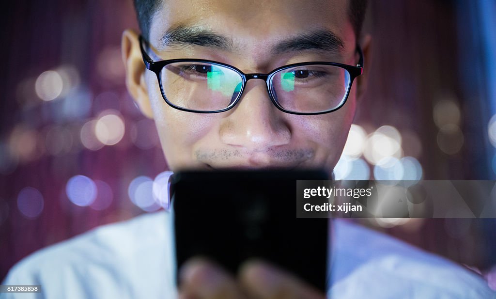 Man using his phone at night