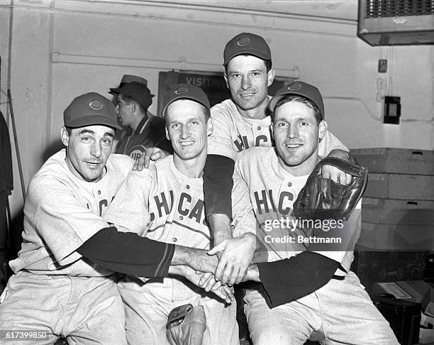 Star Players of the Chicago Cubs join hands in happy celebration in their dressing room following their 9 to 0 victory over the Detroit Tigers in the...