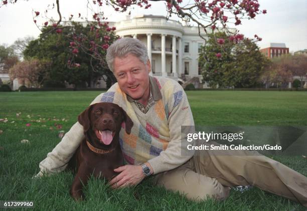 President William Jefferson Clinton posing with Buddy the Dog outside of the White House, April 6, 1999. Image courtesy National Archives. .