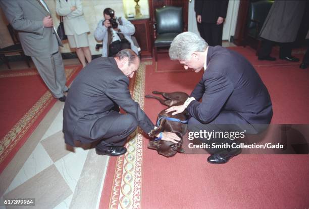 President William Jefferson Clinton and President Jacques Chirac of France petting Buddy the Dog, February 19, 1999. Image courtesy National...