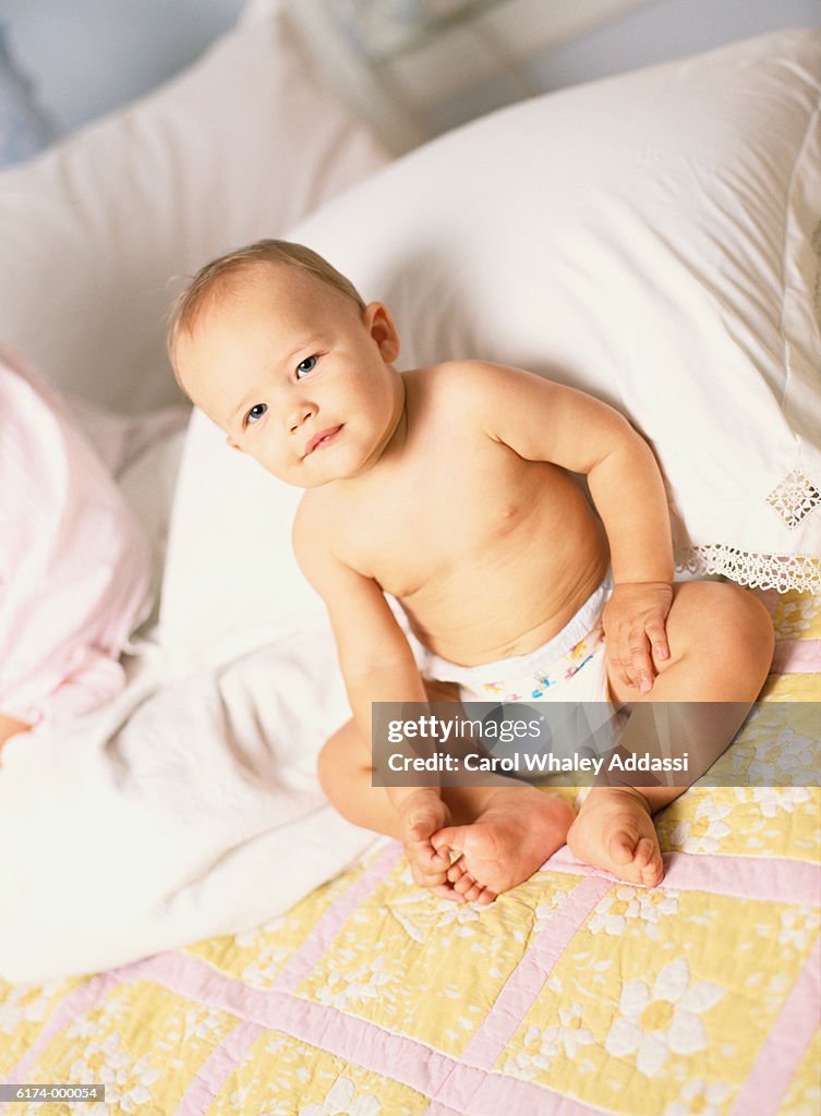 Baby in Diaper with Pillows