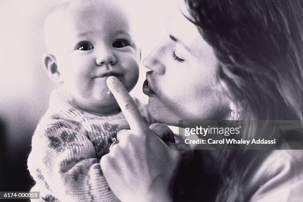 mother silencing baby - carol addassi stock-fotos und bilder