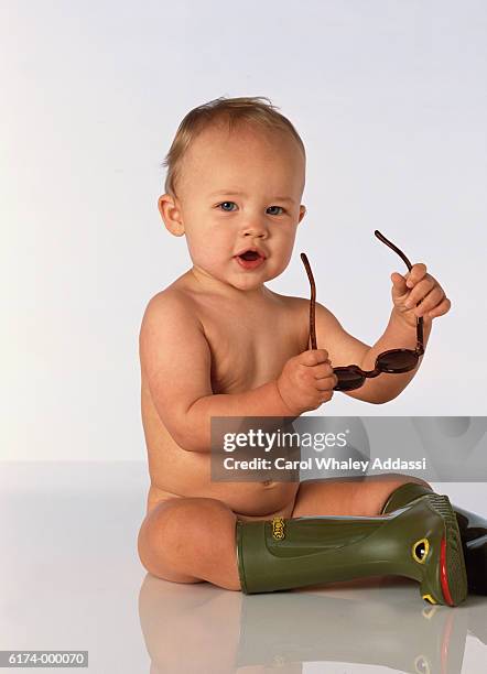 baby in boots with sunglasses - carol addassi stock pictures, royalty-free photos & images
