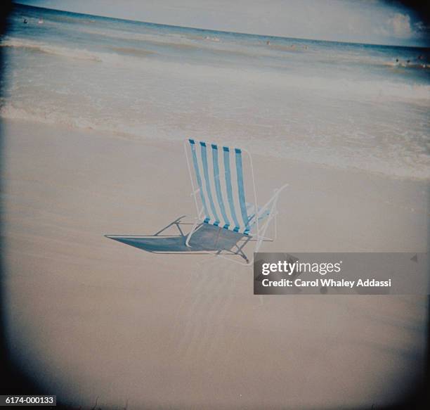 empty deck chair on beach - carol addassi stock-fotos und bilder