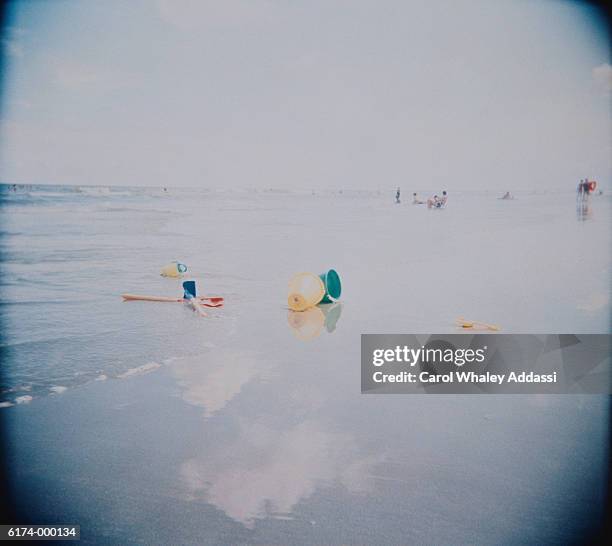 child's toys on beach - carol addassi stock-fotos und bilder