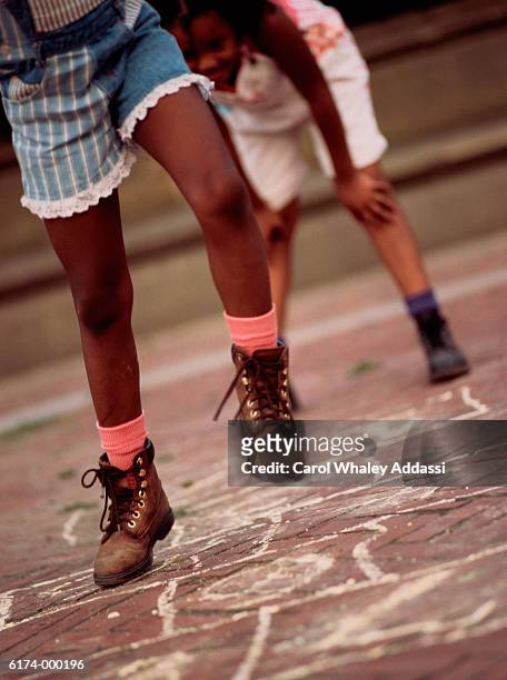 girls playing hopscotch - carol addassi stock pictures, royalty-free photos & images