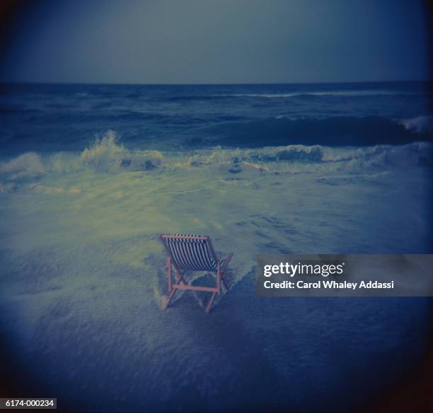 folding chair on beach - carol addassi stock-fotos und bilder