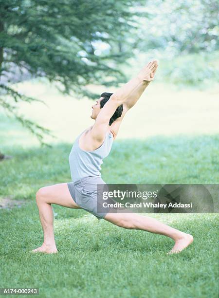 man doing yoga exercise - carol addassi stock-fotos und bilder