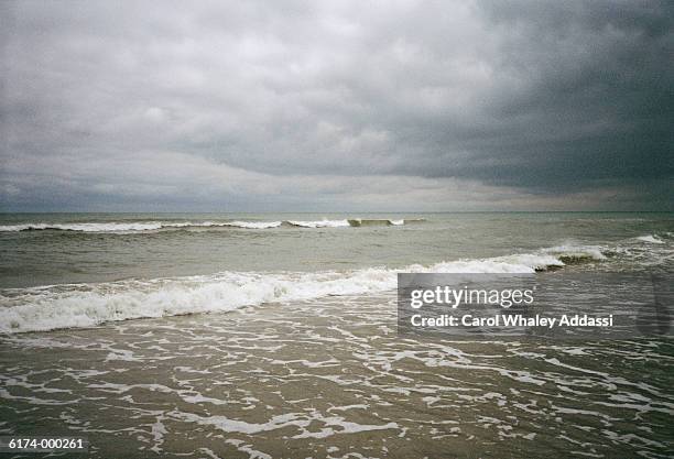 stormy sky over ocean - carol addassi stock-fotos und bilder