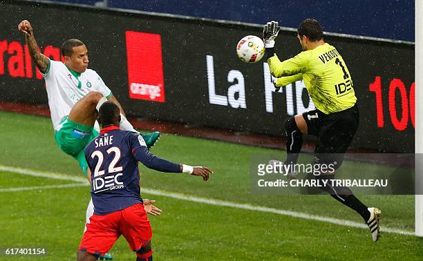 Saint-Etienne's Leo Lacroix vies for the ball with Caen's French goalkeeper Remy Vercoutre during the French L1 football match between Caen and...