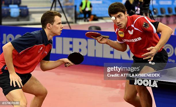 Germany's Patrick Franziska and Denmark's Jonathan Groth play against Poland's Jakub Dyjas and Daniel Gorak in Budapest on October 23, 2016 during...