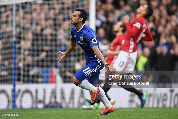 Pedro of Chelsea celebrates scoring his sides first goal during the Premier League match between Chelsea and Manchester United at Stamford Bridge on...