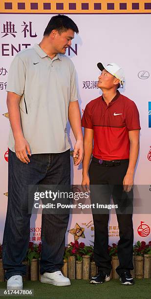 Yao Ming of China congratulates his compatriot Li Haotong after winning the World Celebrity Pro-Am 2016 Mission Hills China Golf Tournament on 23...