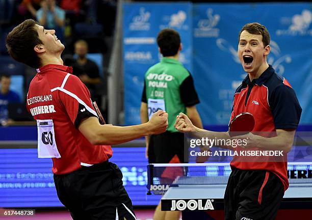 Germany's Patrick Franziska and Denmark's Jonathan Groth celebrate their victory over Poland's Jakub Dyjas Daniel Gorak in "Tuskecsarnok" sports hall...