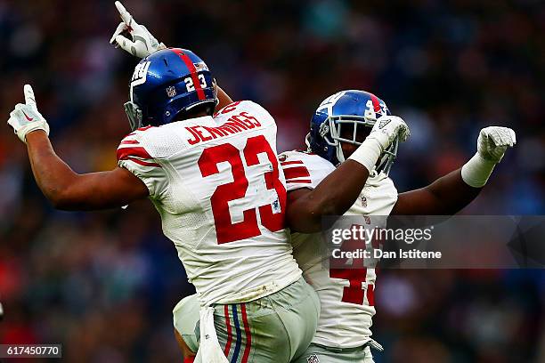 Rashad Jennings of the New York Giants celebrates with Bobby Rainey of the New York Giants after scoring a touchdown during the NFL International...