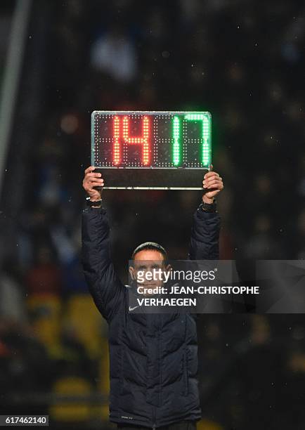 Referee Hakim Ben El Hadj holds an electronic substitution board during the French L1 football match between Metz and Nice on October 23, 2016 at...