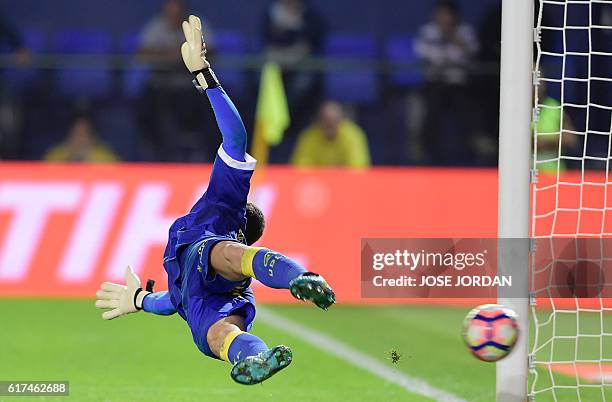 Las Palmas' goalkeeper Raul Lizoain Cruz concedes a goal after failing to stop a penalty kick during the Spanish league football match between...