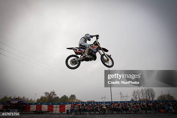 Stuntman jumps on his motorcycle during a stunt car show in Bydgoszcz, Poland, on October 23 2016.