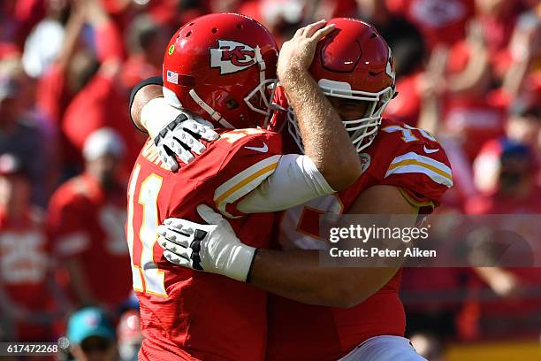 Quarterback Alex Smith of the Kansas City Chiefs celebrates a touchdown pass with Laurent Duvernay-Tardif at Arrowhead Stadium during the second...