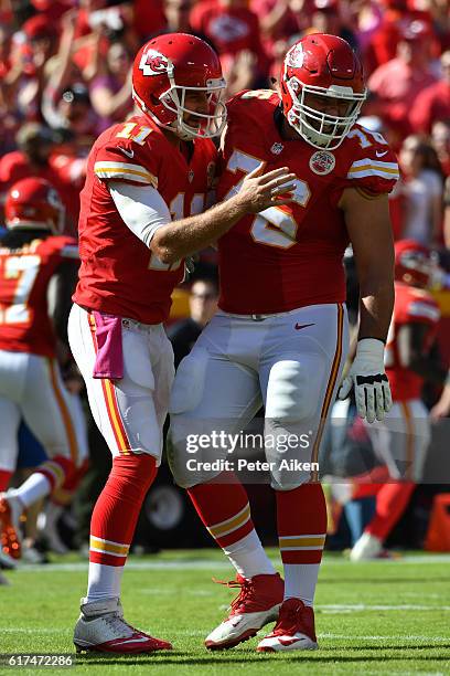 Quarterback Alex Smith of the Kansas City Chiefs celebrates a touchdown pass with Laurent Duvernay-Tardif at Arrowhead Stadium during the second...