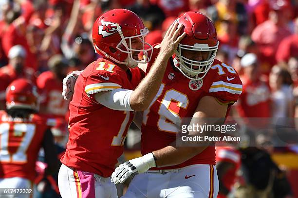 Quarterback Alex Smith of the Kansas City Chiefs celebrates a touchdown pass with Laurent Duvernay-Tardif at Arrowhead Stadium during the second...