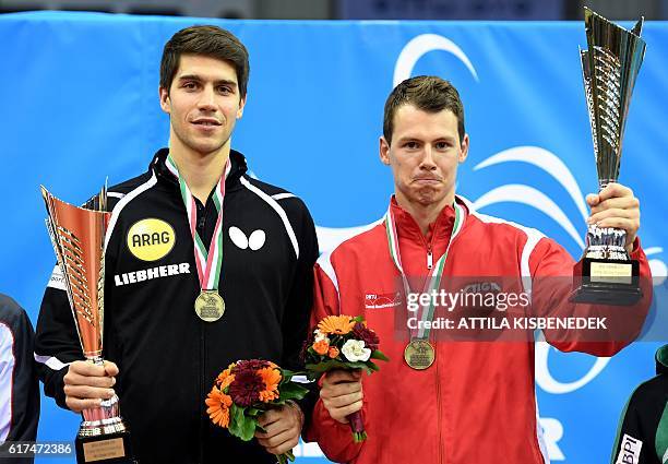 Gold medalists Germany's Patrick Franziska and Denmark's Jonathan Groth poses on the podium with their trophies in "Tuskecsarnok" sports hall of...