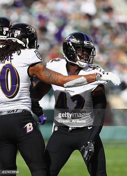 Chris Moore of the Baltimore Ravens celebrates his first quarter touchdown with teammate Marqueston Huff against the New York Jets at MetLife Stadium...
