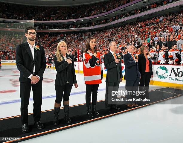 The children of the late owner Ed Snider Samuel, Lindy, Sarena, Jay, Craig and Tina stand on the ice during the pregame opening night ceremonies...