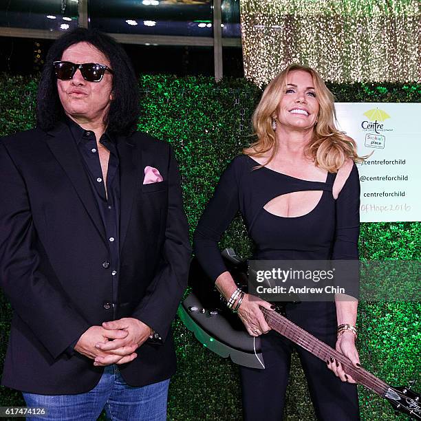 Musician Gene Simmons and Actress Shannon Tweed auction a guitar during the 17th Annual Yellow Brick Road Gala of Hope at Newlands Golf and Country...