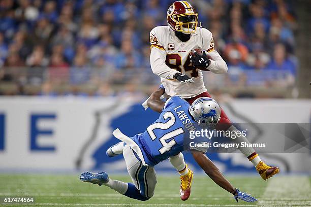 Niles Paul of the Washington Redskins runs for yardage against Nevin Lawson of the Detroit Lions during first half at Ford Field on October 23, 2016...