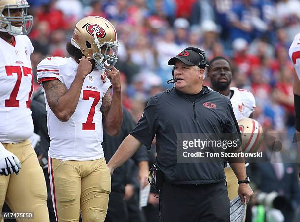 Head coach Chip Kelly of the San Francisco 49ers talks to Colin Kaepernick during NFL game action against the Buffalo Bills at New Era Field on...