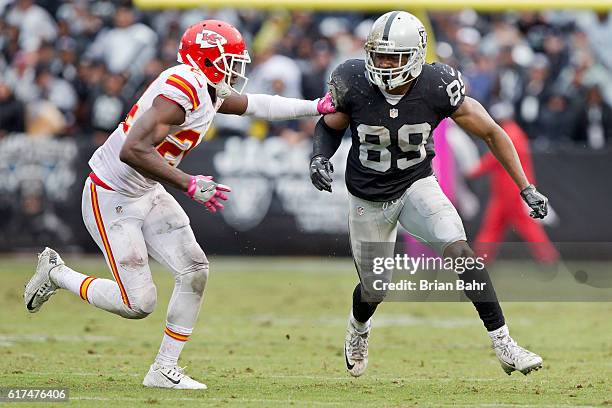 Defensive back D.J. White of the Kansas City Chiefs breaks up a pass with tight coverage against wide receiver Amari Cooper of the Oakland Raiders in...