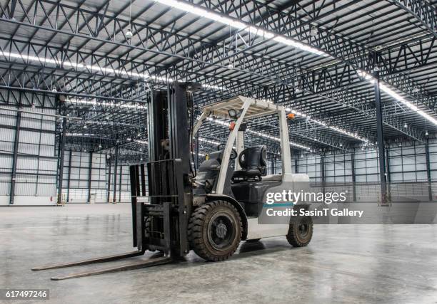 forklift loader in large modern storehouse - forklift stock-fotos und bilder