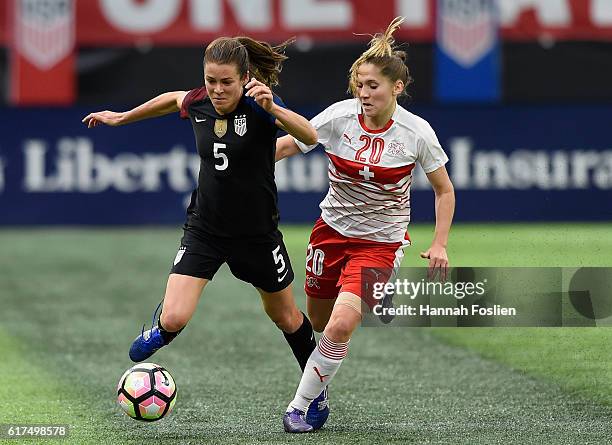 Kelley O'Hara of United States controls the ball against Sandrine Mauron of Switzerland during the first half of the friendly match on October 23,...