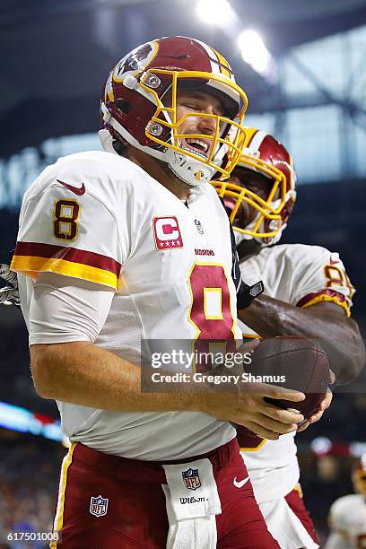 Quarterback Kirk Cousins of the Washington Redskins celebrates his touchdown with Vernon Davis during fourth quarter action against the Detroit Lions...
