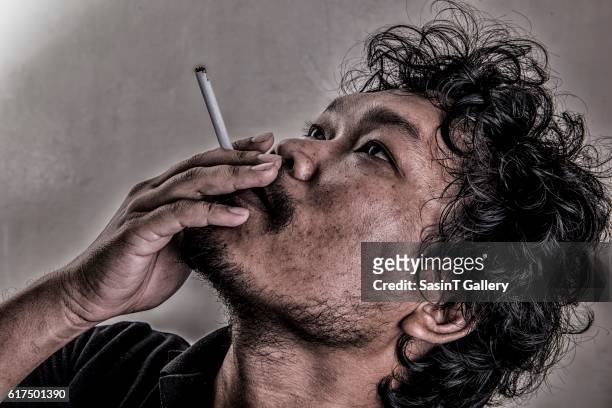 man smoking - orphan medicines stock pictures, royalty-free photos & images