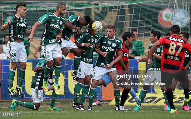 Players of Palmeiras jumps up in the wall during a free kick from Diego Souza of Sport Recife during the match between Palmeiras and Sport Recife for...