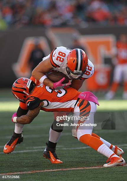 Derron Smith of the Cincinnati Bengals tackles Gary Barnidge of the Cleveland Browns during the fourth quarter at Paul Brown Stadium on October 23,...