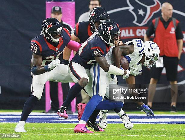Chester Rogers of the Indianapolis Colts is tackled by Johnathan Joseph of the Houston Texans and Andre Hal at NRG Stadium on October 16, 2016 in...