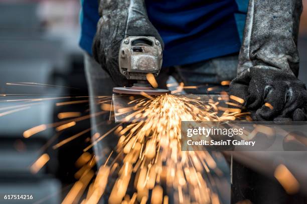 industrial worker cutting metal - 挽く ストックフォトと画像