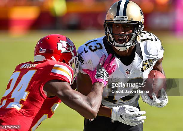 Wide receiver Michael Thomas of the New Orleans Saints begins to be tackled by cornerback D.J. White of the Kansas City Chiefs at Arrowhead Stadium...