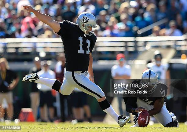 Sebastian Janikowski kicks a field goal off of a hold by Marquette King of the Oakland Raiders during the fourth quarter of the game against the...