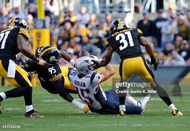 Chris Hogan of the New England Patriots is stripped of the ball by Jarvis Jones of the Pittsburgh Steelers in the first quarter during the game at...