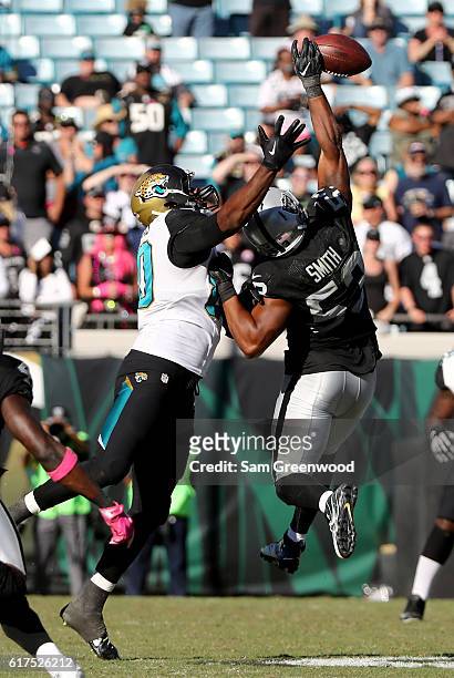 Malcolm Smith of the Oaklnd Raiders breaks up a pass intended for Julius Thomas of the Jacksonville Jaguars during the game at EverBank Field on...