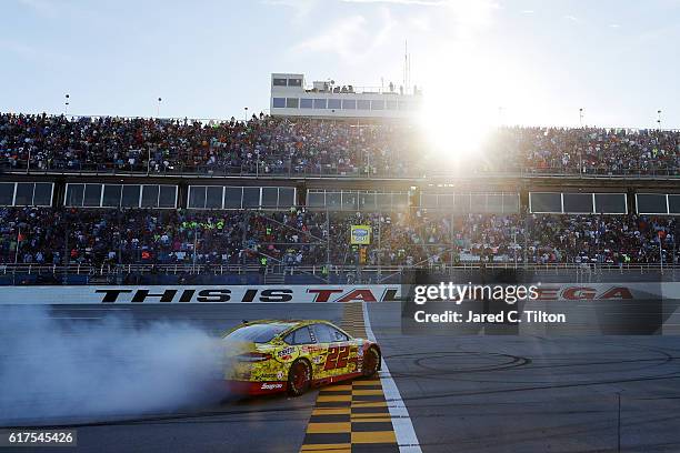 Joey Logano, driver of the Shell Pennzoil Ford, celebrates with a burnout after winning the NASCAR Sprint Cup Series Hellmann's 500 at Talladega...